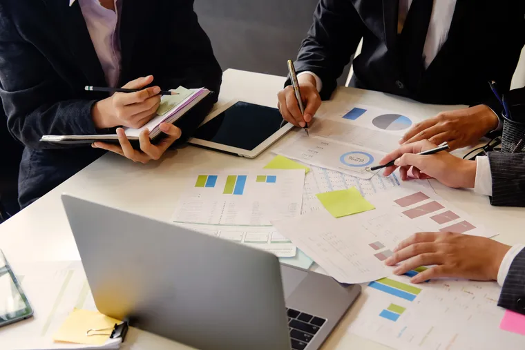 Accounting team reviewing financial reports around a table