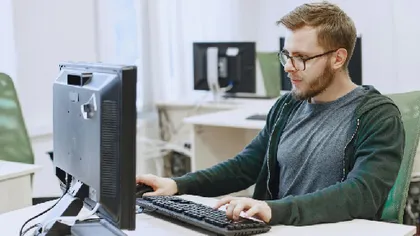A desk phone and headset in a small business office