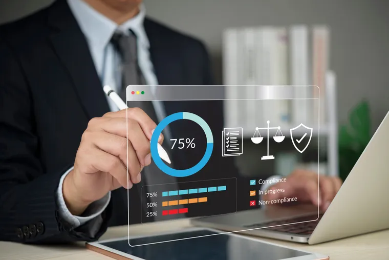Compliance professional reviewing governance and risk metrics