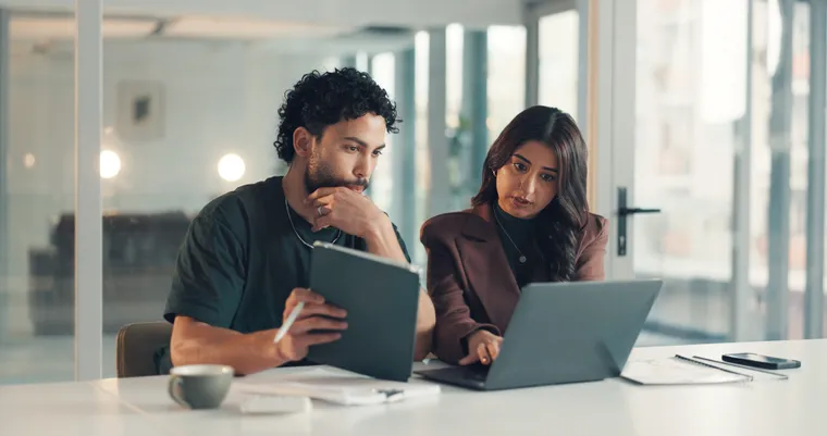 IT support specialists troubleshooting a laptop together